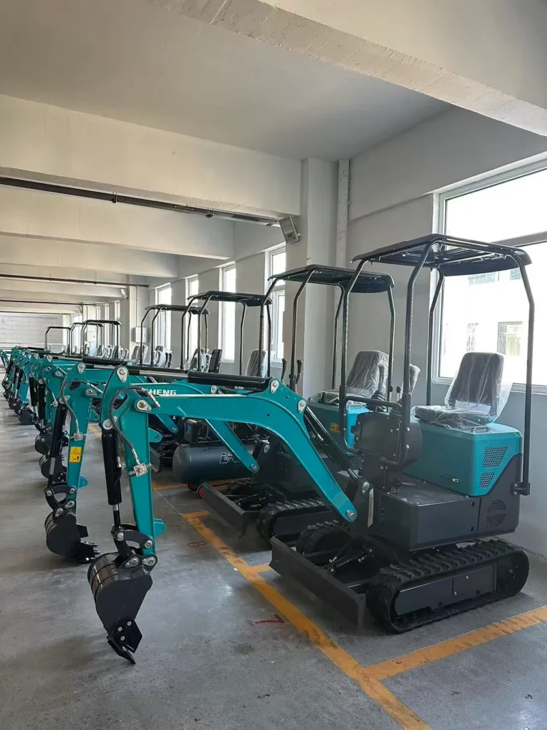 A row of compact yellow mini excavators parked in a clean warehouse.