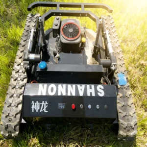 Top-down view of a black "Shenlong SHANNON" remote-controlled lawn mower, featuring its control panel and Loncin engine, on a grass field.