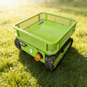 Front side view of a green "神龙" tracked transport platform with mesh guardrail and warning light, operating on a sunlit grass field.