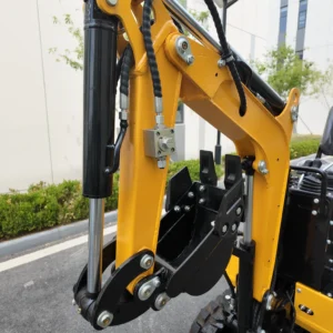 Detailed view of a yellow excavator boom with a black hydraulic cylinder and quick coupler.