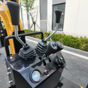 Close-up of a black control console with dual hydraulic joysticks and a digital display.