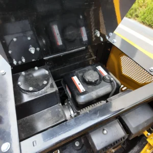 Close-up of a blue mini excavator boom connected to a black digging bucket.