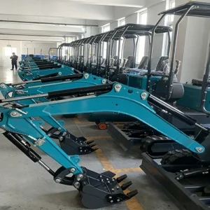 Side view of a row of teal mini excavators, neatly arranged in a finished goods warehouse, ready for shipment.
