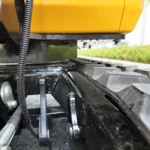 Close-up of durable black rubber tracks and chassis components on a mini excavator.