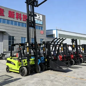 Front view of a lineup of colorful electric forklifts (including green, blue, red models) with attachments like buckets and clamps, parked in a factory yard.