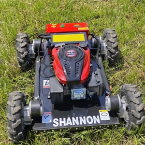 Top view of a red SHANNON lawn mower with 196cc gasoline engine and rugged all-terrain wheels, resting on lush green grass.