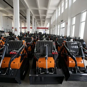 Front view of a large inventory of orange tracked skid steer loaders, neatly arranged in a finished goods warehouse.