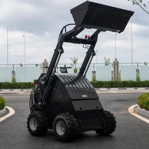 Rear view of black mini skid steer loader with raised bucket, rugged tires and cooling vents
