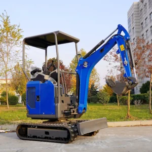 Side view of blue and gray mini excavator with open canopy, bucket and dozer blade on outdoor pavement