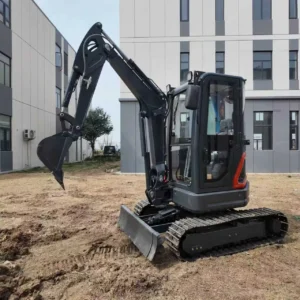 Side view of black and red compact mini excavator with enclosed cabin, bucket and dozer blade on construction site