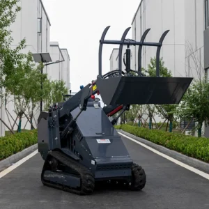 Side-front view of dark gray tracked skid steer loader with raised grapple bucket and rugged rubber tracks