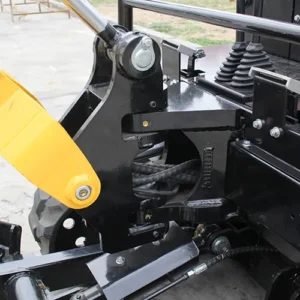 Close-up of mini excavator boom pivot joint with heavy-duty bolts, hydraulic lines and black metal structure