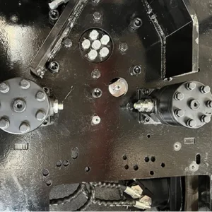 Close-up of mini excavator's chassis hydraulic system with motors, bolts and piping for machinery structure