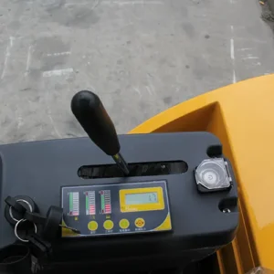 Close-up of mini excavator dashboard with control panel, digital monitor, joystick and ignition key