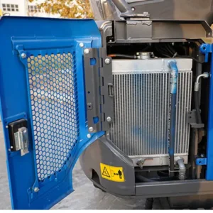 Open view of mini excavator engine compartment showing radiator, hoses and protective grille