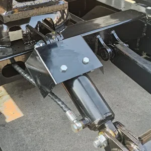 Close-up of mini excavator's hydraulic cylinder, pivot joint and metal frame connection with bolts