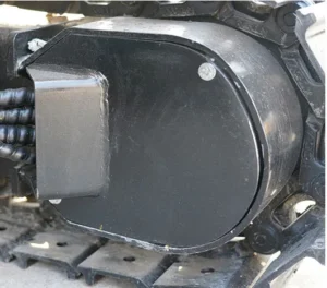 Close-up of mini excavator track drive motor housing with bolts and rubber track links