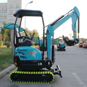 Side rear view of turquoise model 18 mini excavator with yellow tracks, parked in outdoor facility with other equipment