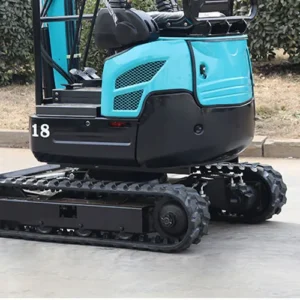 Rear view of turquoise model 18 mini excavator showing tracked undercarriage and rear bodywork in outdoor setting