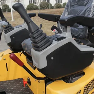 Close-up of yellow mini excavator's cabin joystick control unit, safety lever and operator seat with plastic cover