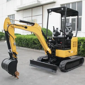 Side front view of yellow model 20 mini excavator with open canopy, bucket and dozer blade on factory pavement