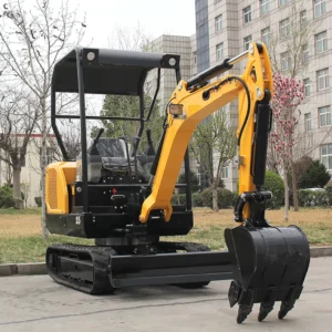 Side front view of yellow model 25 mini excavator with canopy, bucket and dozer blade in factory yard