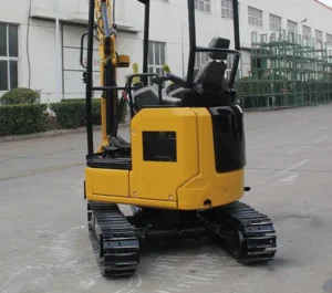 Rear view of yellow mini excavator with open canopy, operator controls and tracked undercarriage