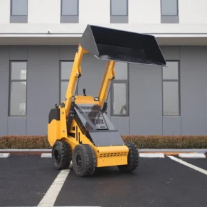 Side-rear view of yellow mini skid steer loader with high-lift bucket, rugged tires and compact body