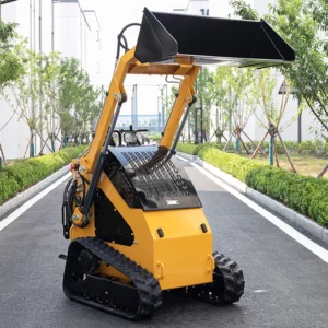 Front view of yellow tracked mini skid steer loader with high-lift bucket and rugged rubber tracks