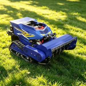 Blue remote-controlled crawler lawn mower with flail attachment, operating on a green grass lawn