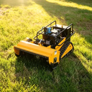 Yellow remote-controlled crawler flail mower with roll bar, operating on a green grass lawn