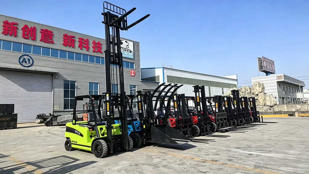 Lineup of multi-color electric forklifts with various attachments (forks, buckets, clamps) displayed outside a factory, showing different configurations